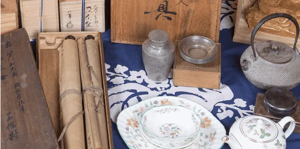 床に食器や掛軸などが並んでいる様子